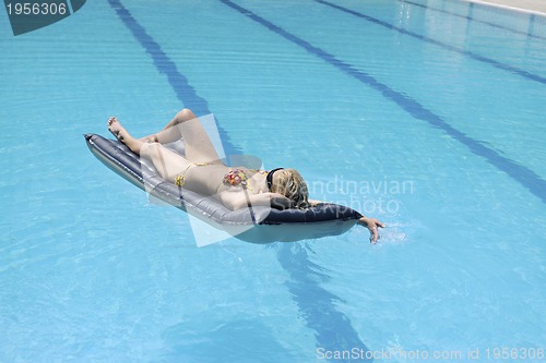 Image of beautiful woman relax on swimming pool