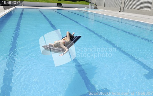 Image of beautiful woman relax on swimming pool