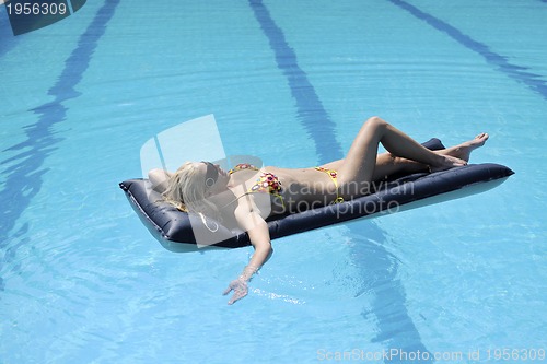Image of beautiful woman relax on swimming pool