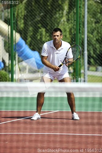 Image of young man play tennis outdoor