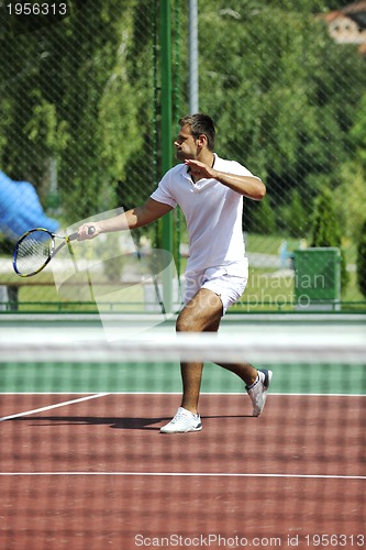 Image of young man play tennis outdoor