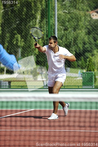 Image of young man play tennis outdoor