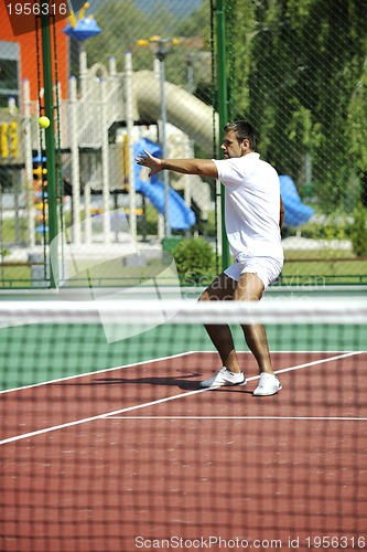 Image of young man play tennis outdoor