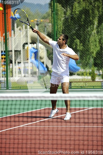 Image of young man play tennis outdoor