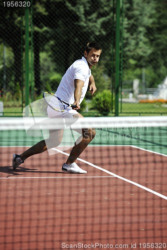 Image of young man play tennis outdoor
