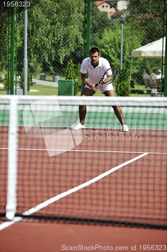 Image of young man play tennis outdoor