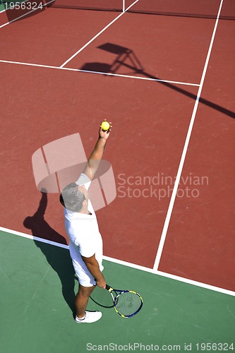 Image of young man play tennis outdoor