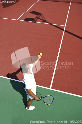 Image of young man play tennis outdoor