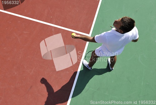 Image of young man play tennis outdoor