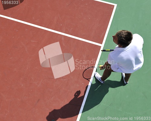 Image of young man play tennis outdoor