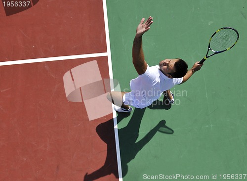 Image of young man play tennis outdoor