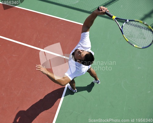 Image of young man play tennis outdoor