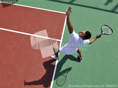 Image of young man play tennis outdoor