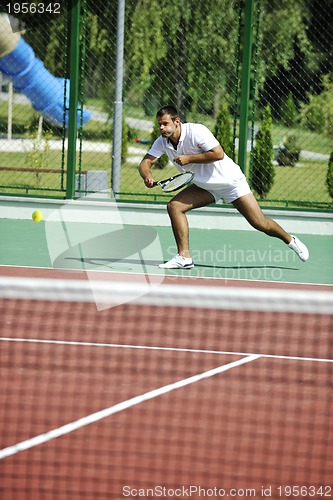 Image of young man play tennis outdoor