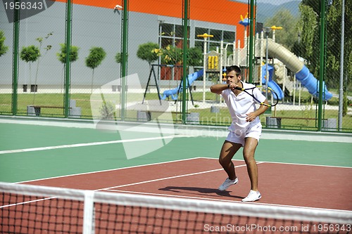 Image of young man play tennis outdoor