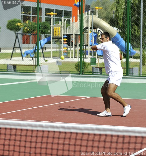 Image of young man play tennis outdoor