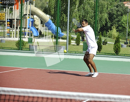 Image of young man play tennis outdoor