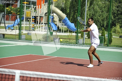 Image of young man play tennis outdoor