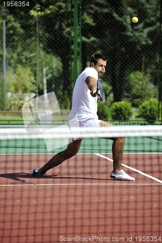 Image of young man play tennis outdoor