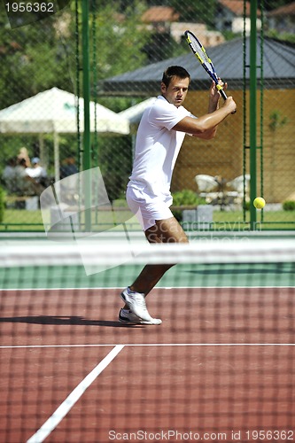 Image of young man play tennis outdoor