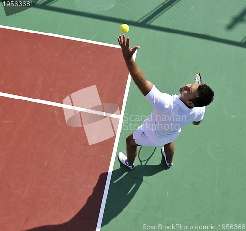 Image of young man play tennis outdoor