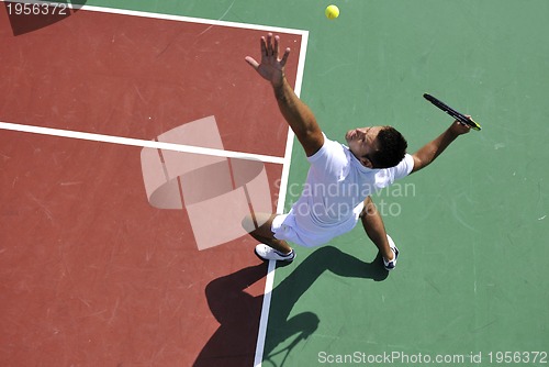 Image of young man play tennis outdoor