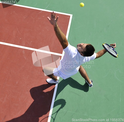 Image of young man play tennis outdoor