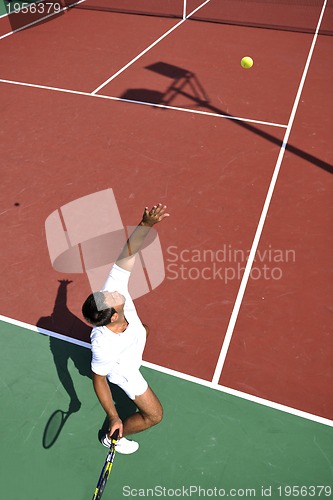 Image of young man play tennis outdoor