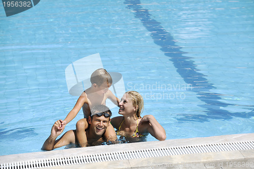 Image of happy father and son at swimming pool