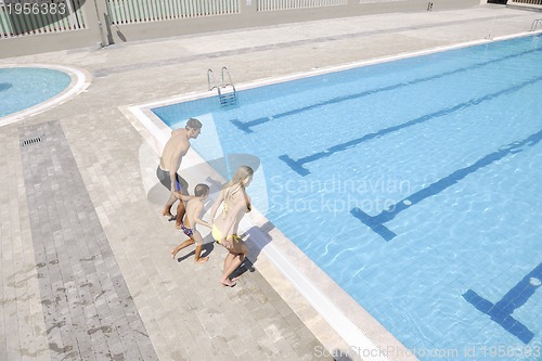 Image of happy young family have fun on swimming pool