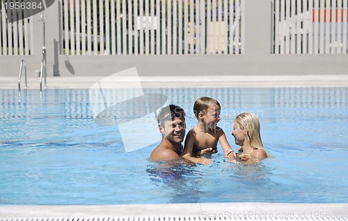 Image of happy young family have fun on swimming pool