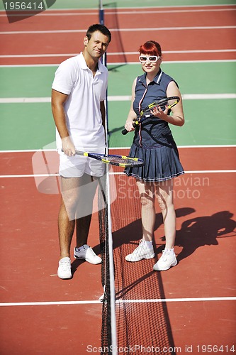 Image of happy young couple play tennis game outdoor