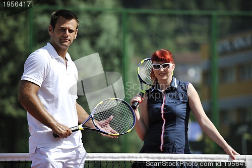 Image of happy young couple play tennis game outdoor