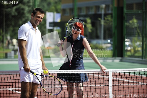 Image of happy young couple play tennis game outdoor