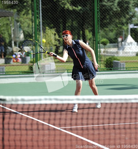 Image of young woman play tennis game outdoor