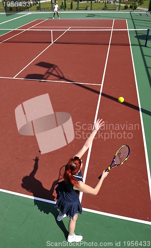 Image of young woman play tennis game outdoor