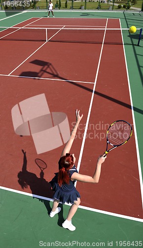 Image of young woman play tennis game outdoor