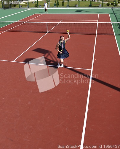 Image of young woman play tennis game outdoor