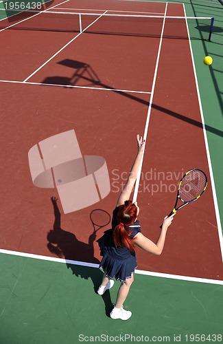 Image of young woman play tennis game outdoor
