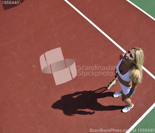 Image of young woman play tennis game outdoor