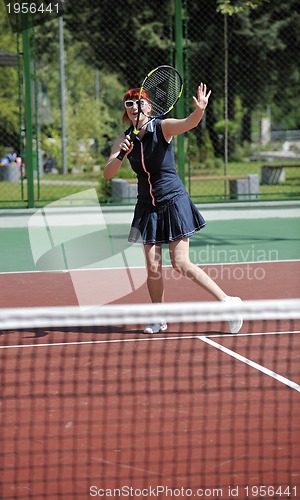 Image of young woman play tennis game outdoor