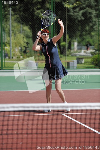 Image of young woman play tennis game outdoor