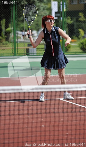 Image of young woman play tennis game outdoor