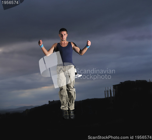 Image of young man dancing and jumping  