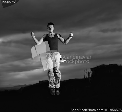 Image of young man dancing and jumping  