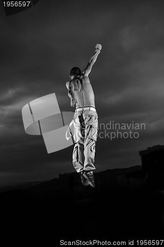 Image of young man dancing and jumping  