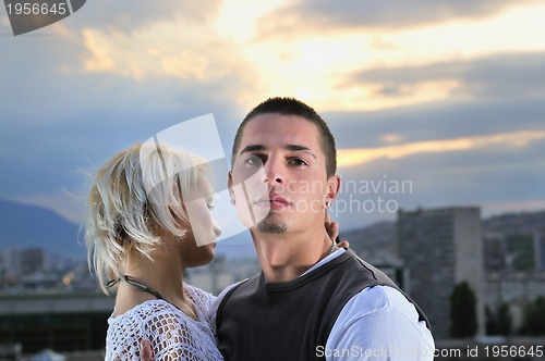 Image of romantic urban couple dancing on top of  bulding