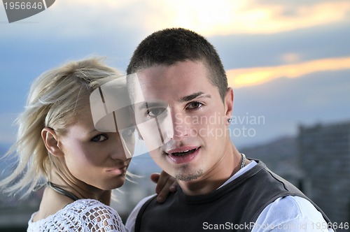 Image of romantic urban couple dancing on top of  bulding