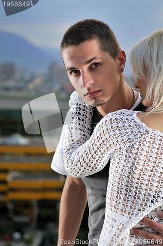 Image of romantic urban couple dancing on top of  bulding