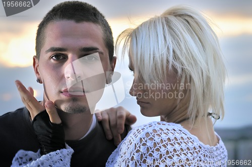 Image of romantic urban couple dancing on top of  bulding